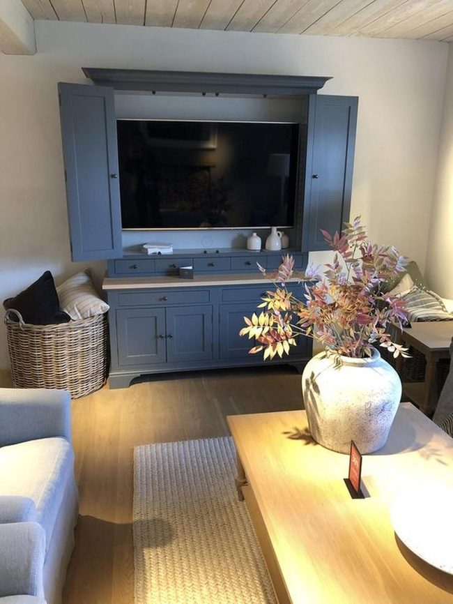 Blue Cabinet Anchors Warm Wood Space