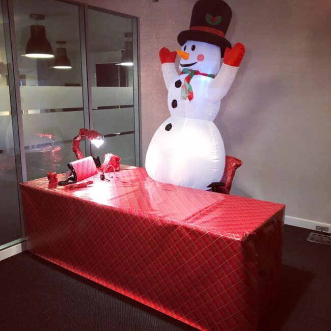 Festive Desk Décor Featuring Inflatable Snowman