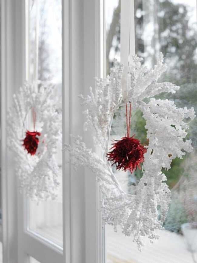Bright Red Accents on Snowy Wreaths